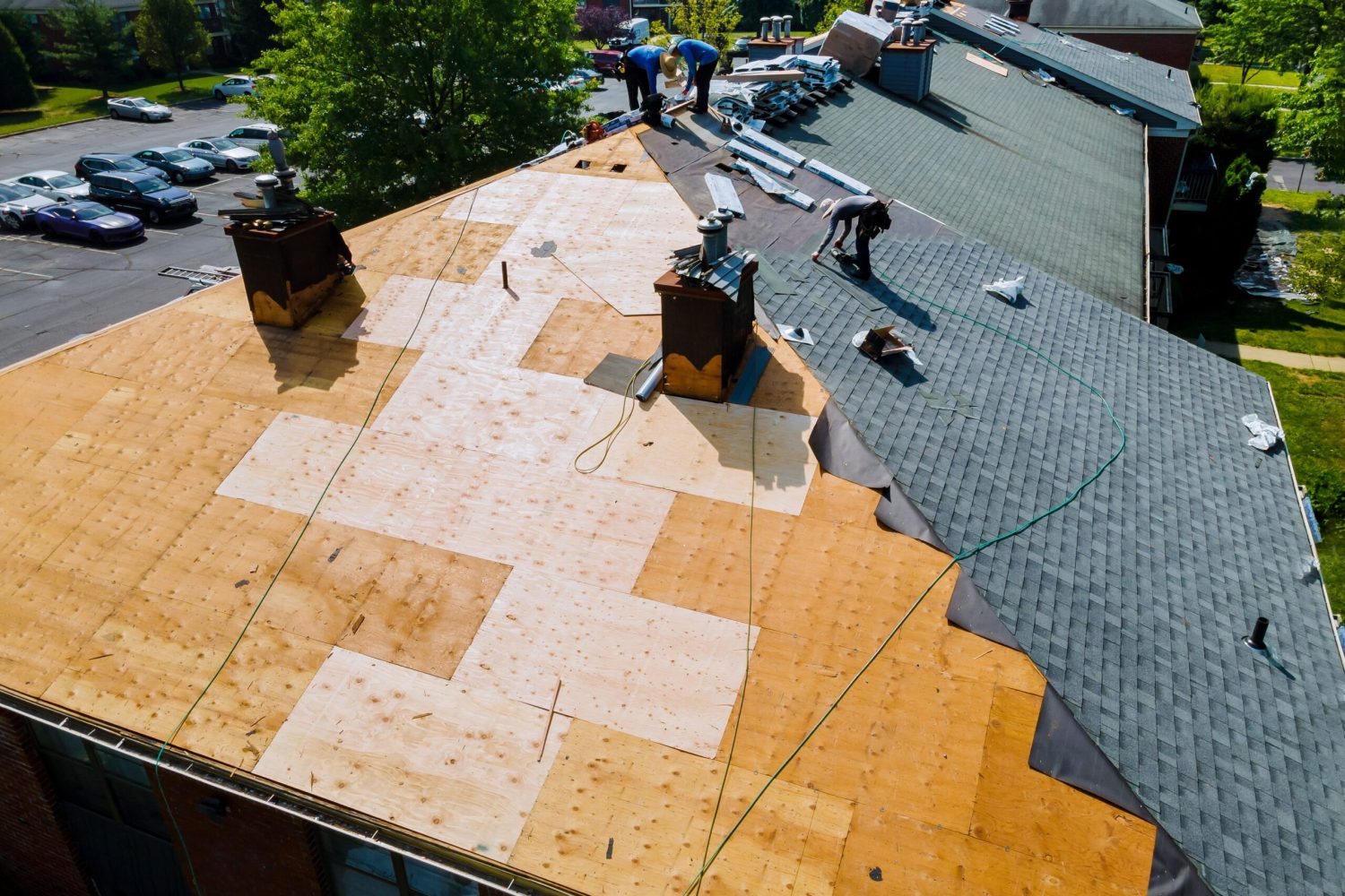 Roof repairs old roof replacement with new shingles of an apartment building