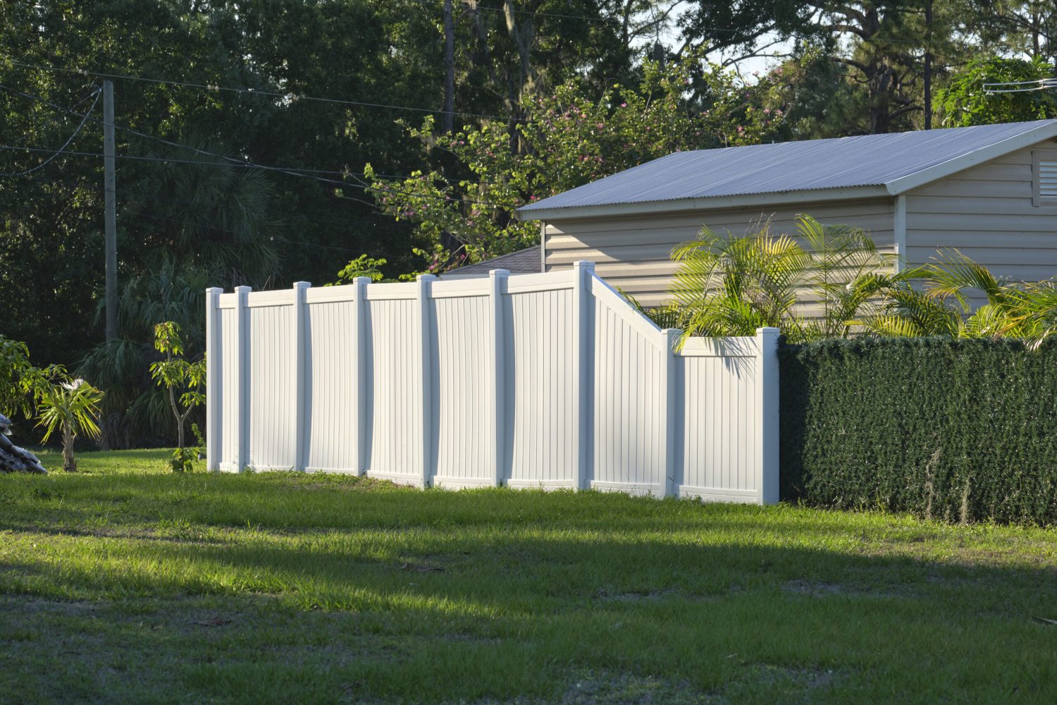 White plastic fence for back yard protection and privacy.